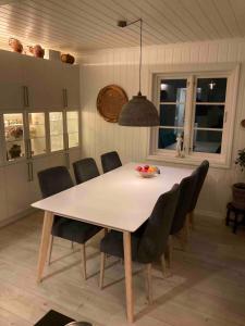 a dining room table and chairs in a kitchen at Short way to city centre and Aker Solutions! in Stord