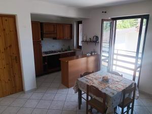 a kitchen with a table and a table and a window at Home Friends in Camigliatello Silano