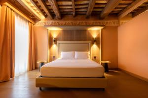 a bedroom with a bed and a large window at Palazzo De Gregorio - Apartments in Palermo