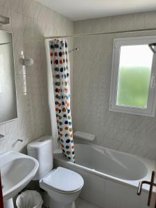 a bathroom with a tub and a toilet and a sink at Angelinas Villas 2 Hab con Piscina in Cala Blanca