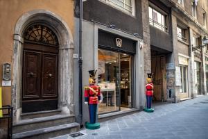 a street with two fire hydrants in front of a store at San Martino Suite in Pisa