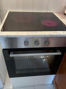 a stove with two pizzas on top of it in a kitchen at Angelinas Villas 2 Hab con Piscina in Cala Blanca