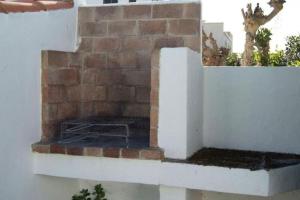 a brick oven on the side of a building at Angelinas Villas 2 Hab con Piscina in Cala Blanca +4 photos