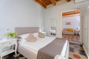a bedroom with a large bed and a living room at San Martino Suite in Pisa