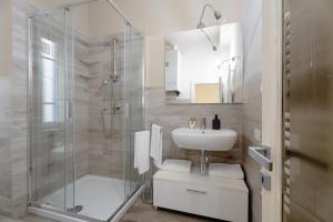 a bathroom with a glass shower and a sink at San Martino Suite in Pisa