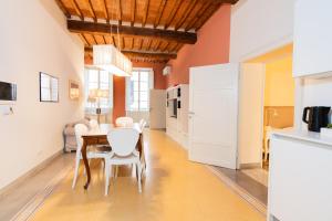a kitchen and dining room with a table and chairs at San Martino Suite in Pisa +11 photos