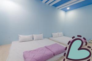Ένα ή περισσότερα κρεβάτια σε δωμάτιο στο Mu Yu B&B