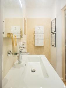 a white bathroom with a sink and a mirror at T2 center parking air conditioning Wi-Fi in Avignon +13 photos