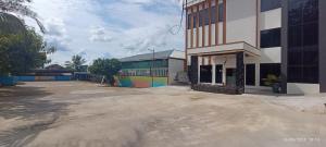 an empty parking lot in front of a building at Arraudah Hotel Syari'ah in Paringin