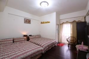 Ένα ή περισσότερα κρεβάτια σε δωμάτιο στο Fangyi Homestay