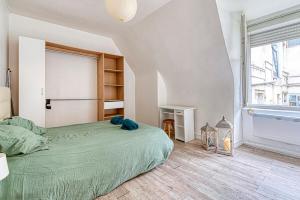 Giường trong phòng chung tại Le Nid - Place Imbach