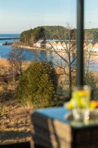 a table with a view of a body of water at Luxury Apartment 23 basen i sauna D&D Apartments in Dziwnów