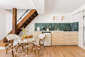 a kitchen with a table and chairs in a room at Weekn'spa Tournus in Tournus