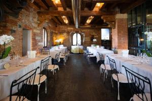 a room with long tables and chairs in a building at Tenuta Molino dei Sassi in Zevio