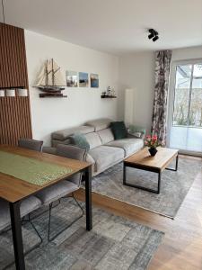 a living room with a couch and a table at Ostseemöwe NEU in Zingst