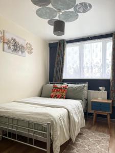 a bedroom with a bed and a ceiling at Penn Gardens Flat 1 - 2 - 3 & 4 Apartments in Havering atte Bower