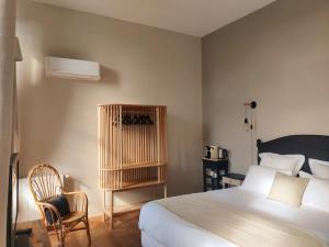 Postel nebo postele na pokoji v ubytování Chambres d'hôtes - Bed and Breakfast Les Palmiers