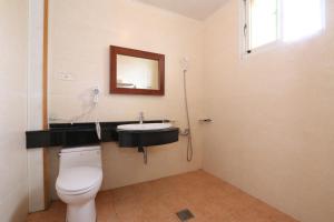 a bathroom with a toilet and a sink and a mirror at Fangyi Homestay in Ji'an