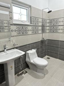 a bathroom with a toilet and a sink at 2 BHK GF - Villa in Bahria Enclave, Islamabad in Islamabad