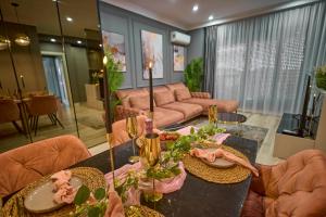 a living room with a table and a couch at Cozy Glow Loft in Bucharest