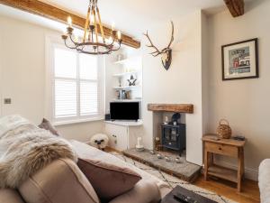 a living room with a couch and a fireplace at Glynside in Conwy