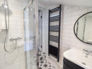 a bathroom with a shower and a sink at Glynside in Conwy +16 photos