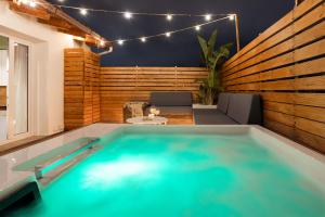 a large swimming pool in a room with a patio at Le Terrazze dei Candelai "boutique apartments" in Palermo