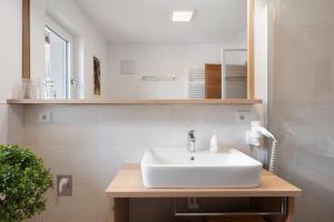 a bathroom with a white sink and a mirror at Haus Pferscher in Barbiano +56 photos