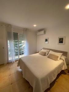 a bedroom with a bed with white sheets and a window at Casa Rural Roa in Casinos +35 photos