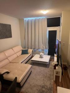 a living room with a couch and a table at Private and Comfort Room in Mississauga
