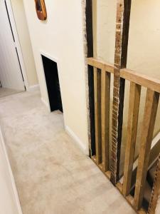 a hallway with a fireplace in a house at Wisteria Cottage in Gravesend +38 photos