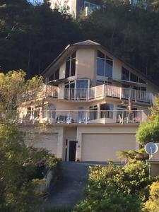 a large white house with a garage at Absolute Bliss Apartments in Paihia