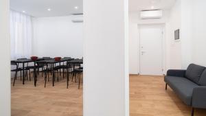 a living room with a table and a couch at Lovely Rooms by Rentbeat in Civitavecchia