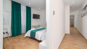 a bedroom with a bed and a green curtain at Lovely Rooms by Rentbeat in Civitavecchia
