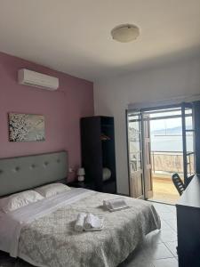 a bedroom with a bed with two shoes on it at Sail inn Kalymnos in Kalymnos +18 photos