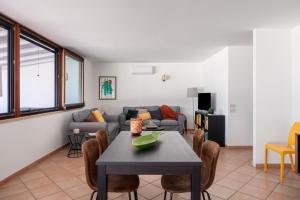 a living room with a table and a couch at Sapore di Sale by DomuSicily in Palermo