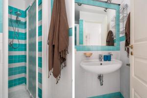 a bathroom with a sink and a mirror at Sapore di Sale by DomuSicily in Palermo +21 photos