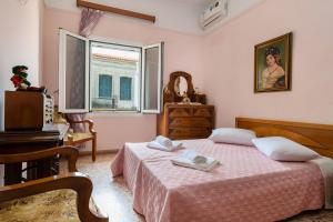 a bedroom with a bed and a dresser and a mirror at Chania Vintage Escape - sea view Gem by old port in Chania Town