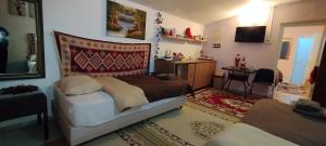a bedroom with a bed and a desk in it at Trikala Apartments 3 in Tríkala