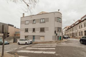 a white car parked in front of a building at Boutique Suites by Hosty in Porto