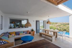 a living room with a couch and a table at Villa Punta Europa - Private pool with Seaview in Torreguadiaro