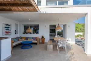 an open living room with a table and chairs at Villa Punta Europa - Private pool with Seaview in Torreguadiaro