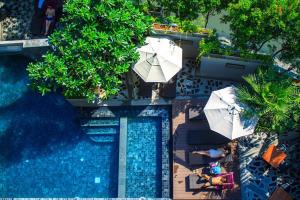an overhead view of a swimming pool with umbrellas at Mazi Design Hotel by Kalima - SHA Plus in Patong Beach