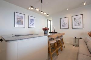 eine Küche mit einer Bar mit Hockern und einem Sofa in der Unterkunft Villa Lume Nea Skioni by Halkidiki Villas in Nea Skioni + 44 Fotos