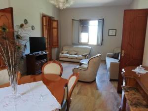 a living room with a table and chairs at Villa Giardini in Balestrate