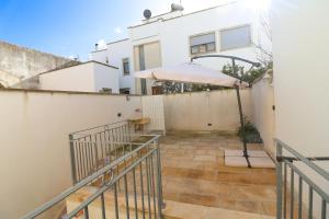 a patio with an umbrella next to a building at Casa Malika a Otranto in Otranto