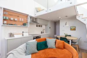 a kitchen with a couch and a table in a room at Award-Winning Cottage 5 Min Walk to the Beach in Bembridge
