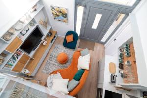 an overhead view of a living room with an orange couch at Award-Winning Cottage 5 Min Walk to the Beach in Bembridge
