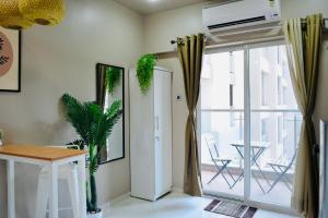 a living room with a sliding glass door to a balcony at Private Studio Apartments with Balcony in New Kalyani Nagar in Pune