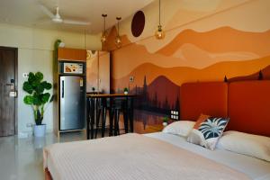 a bedroom with a bed and a kitchen with a bar at Private Studio Apartments with Balcony in New Kalyani Nagar in Pune +107 photos